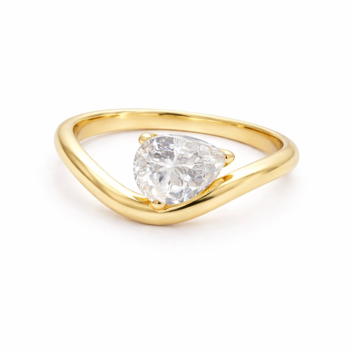 The Kouvr Zuri 2 carat pear cut diamond engagement ring in 18k yellow gold with a modern bypass band, shown on a white background.