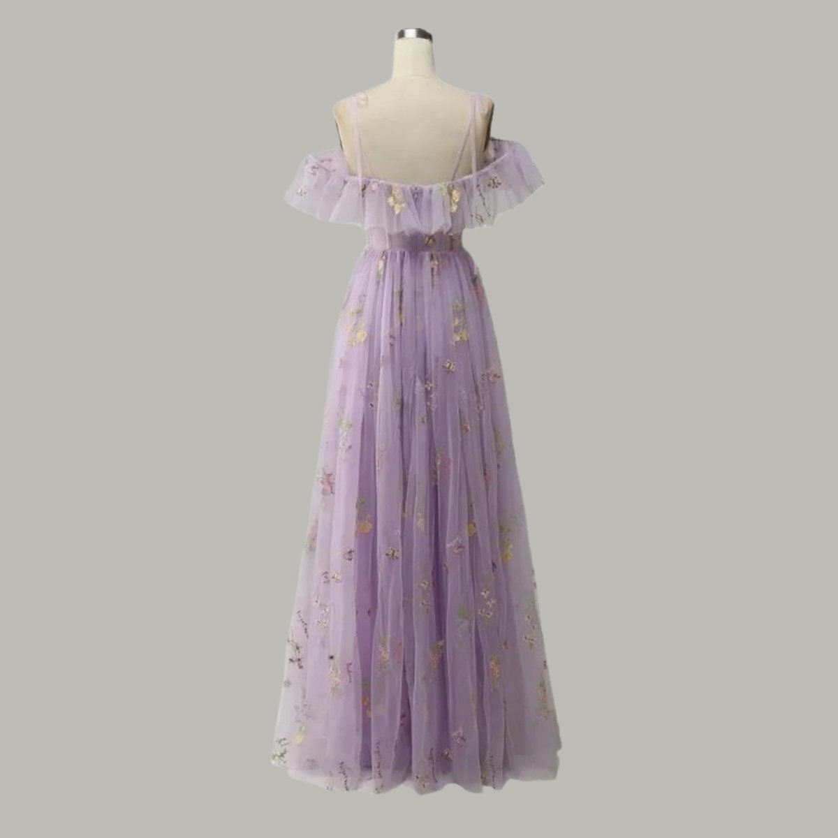 Back mannequin view of the Kouvr off-shoulder floral embroidered prom gown in lightweight light purple tulle fabric.
