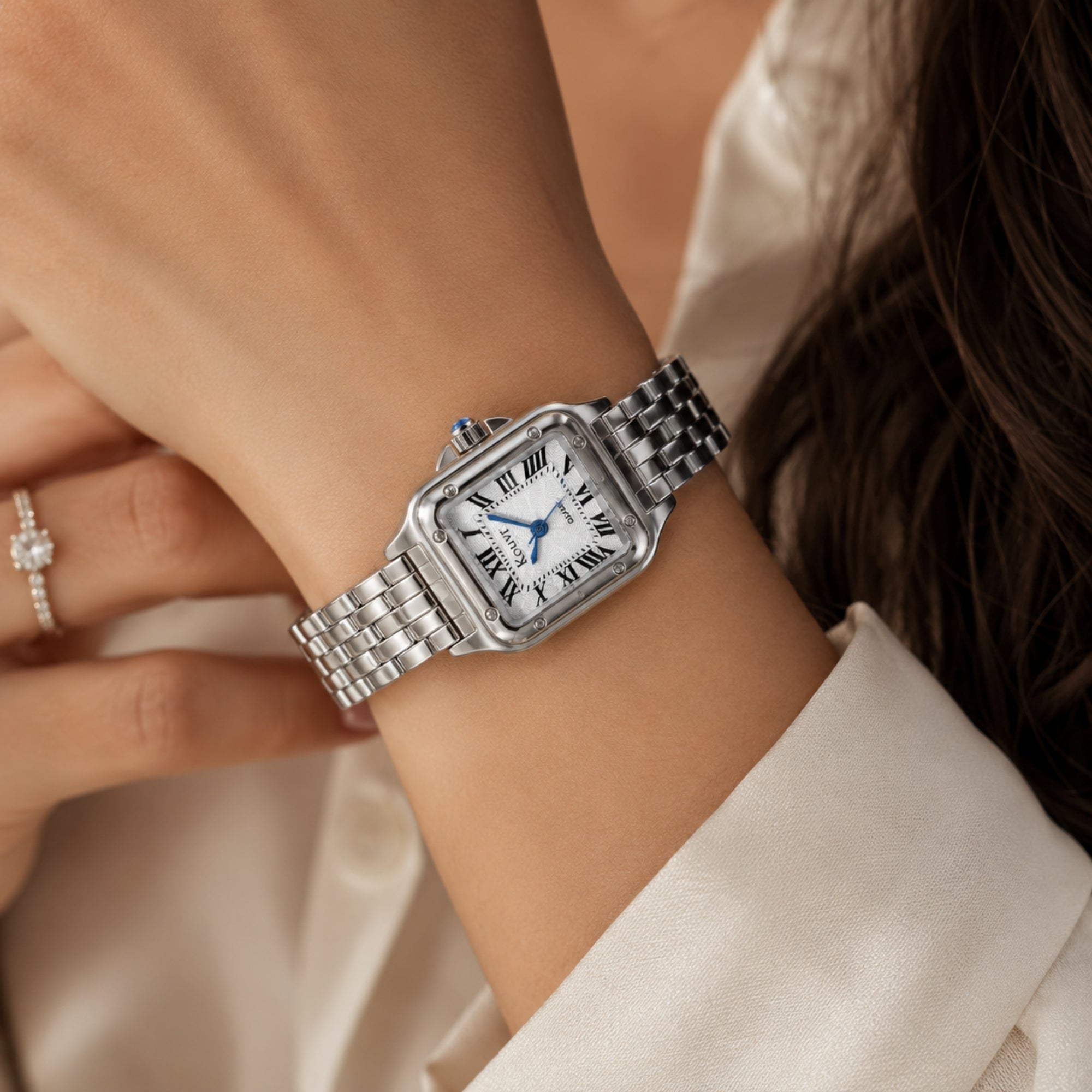 Woman wearing a silver Kouvr classic square watch with a white silk blouse, demonstrating elegant everyday styling and quiet luxury aestheti