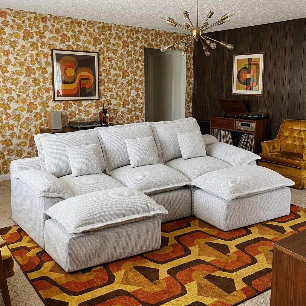 Modern light grey sectional sofa styled with a black marble coffee table and dark accent walls.