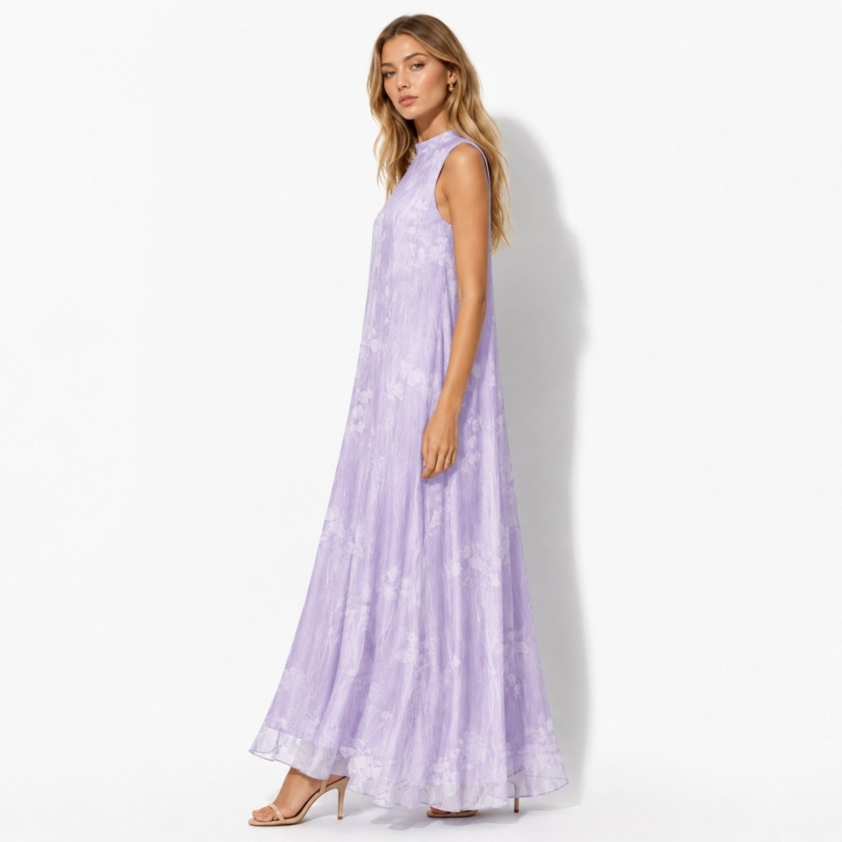 Side profile of a flowing light purple organza trapeze maxi dress with subtle botanical print