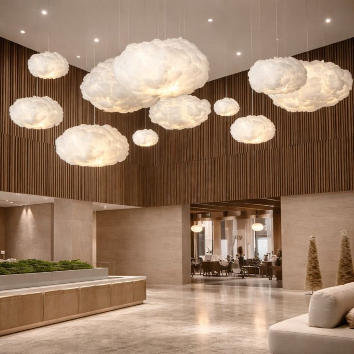 Many aesthetic cloud lights hanging in a bright, minimalis main room in a lobby