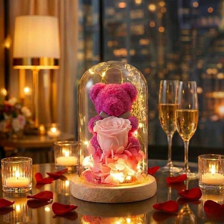 Vibrant magenta pink preserved flower bear in a lighted glass dome, perfect for Valentine's Day or Mother's Day.