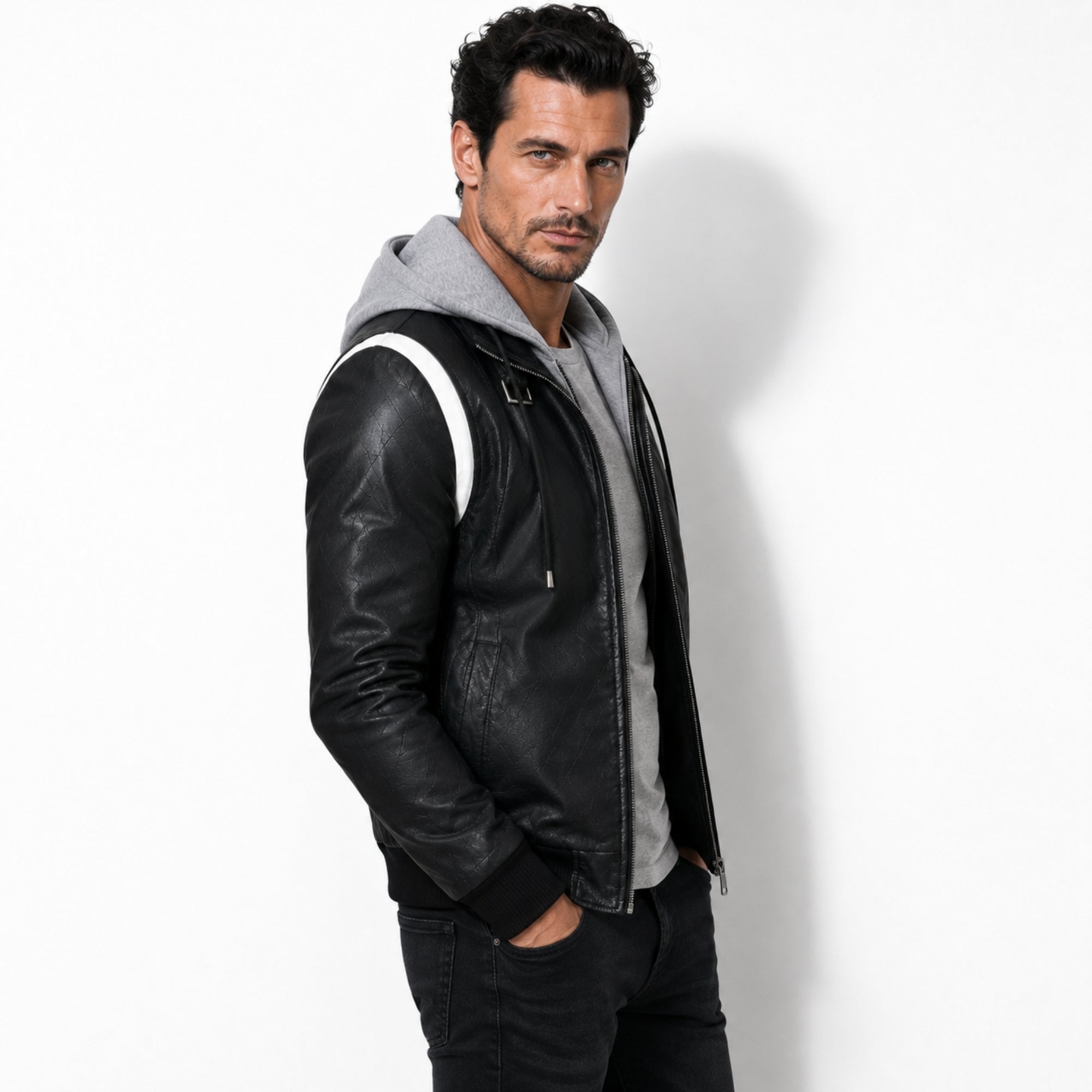  Side profile of a man wearing the Kouvr black hooded leather streetwear jacket showing quilted texture details.