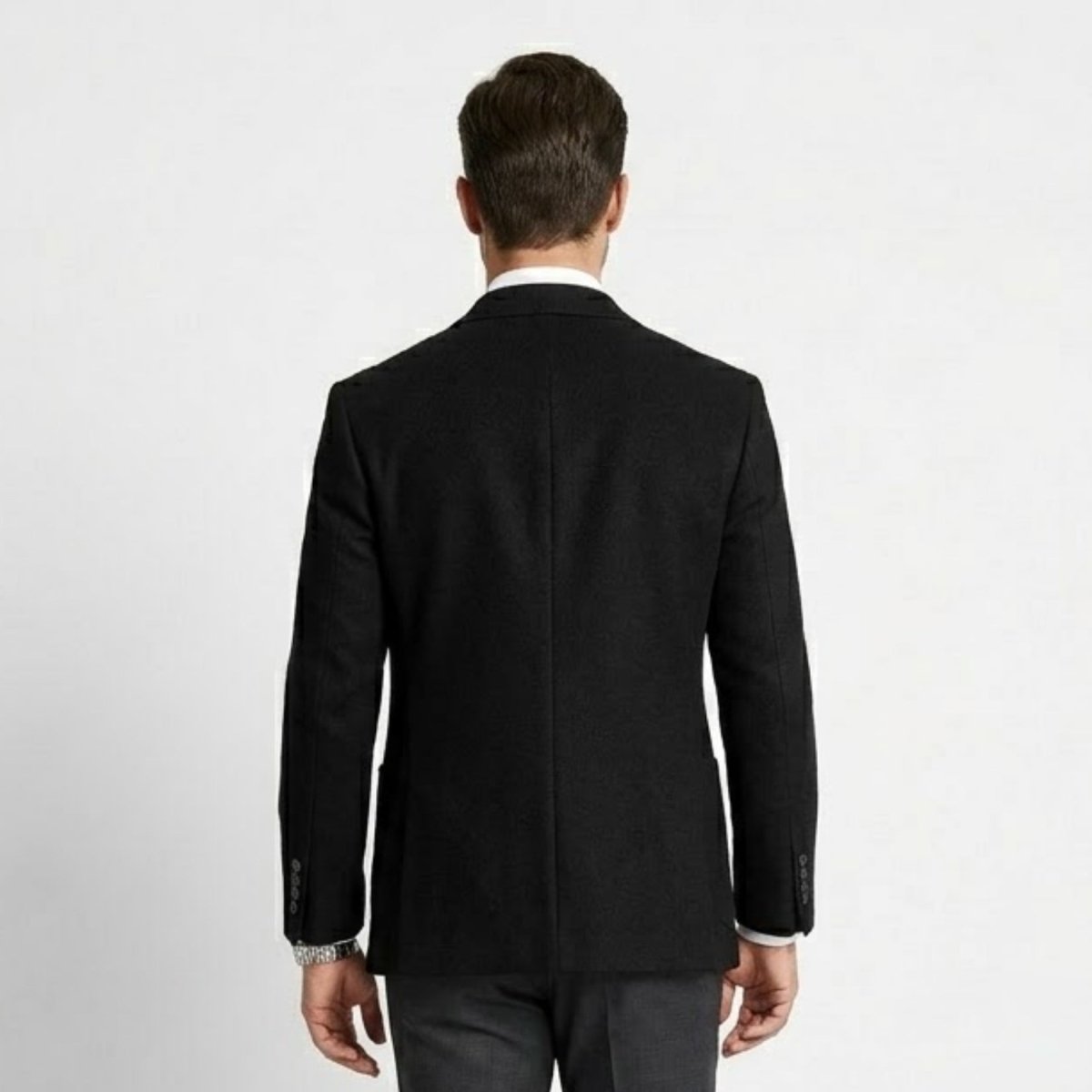 Back view of men's black slim fit sport coat showing double back vents and tailored seams.