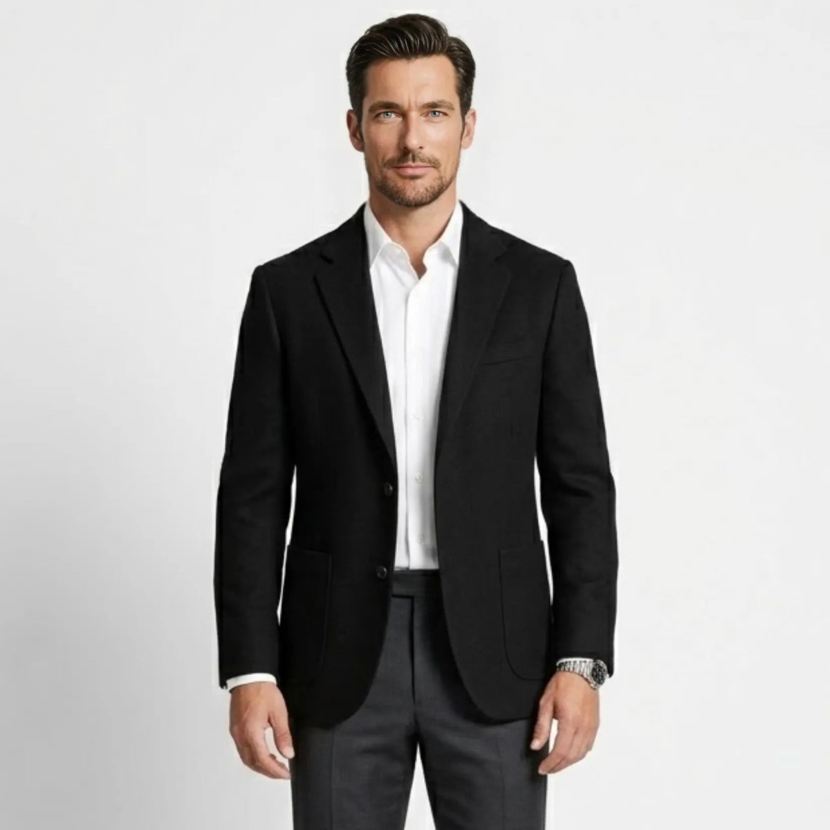 Men's black tailored fit wool blazer worn by a male model over a crisp white dress shirt.