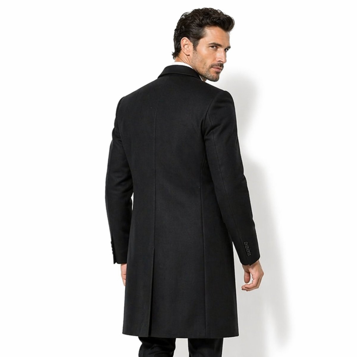 Back view of men's black formal overcoat showing the single center back vent and precise tailored fit across the shoulders.