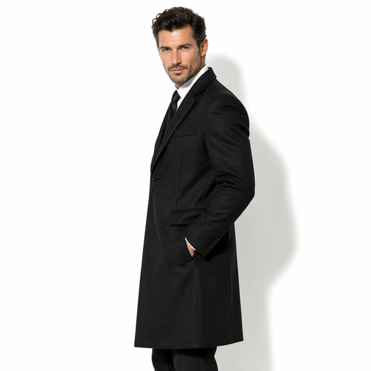 Side profile of men's classic black winter topcoat with hand comfortably resting in the front pocket, styled for business professional wear.