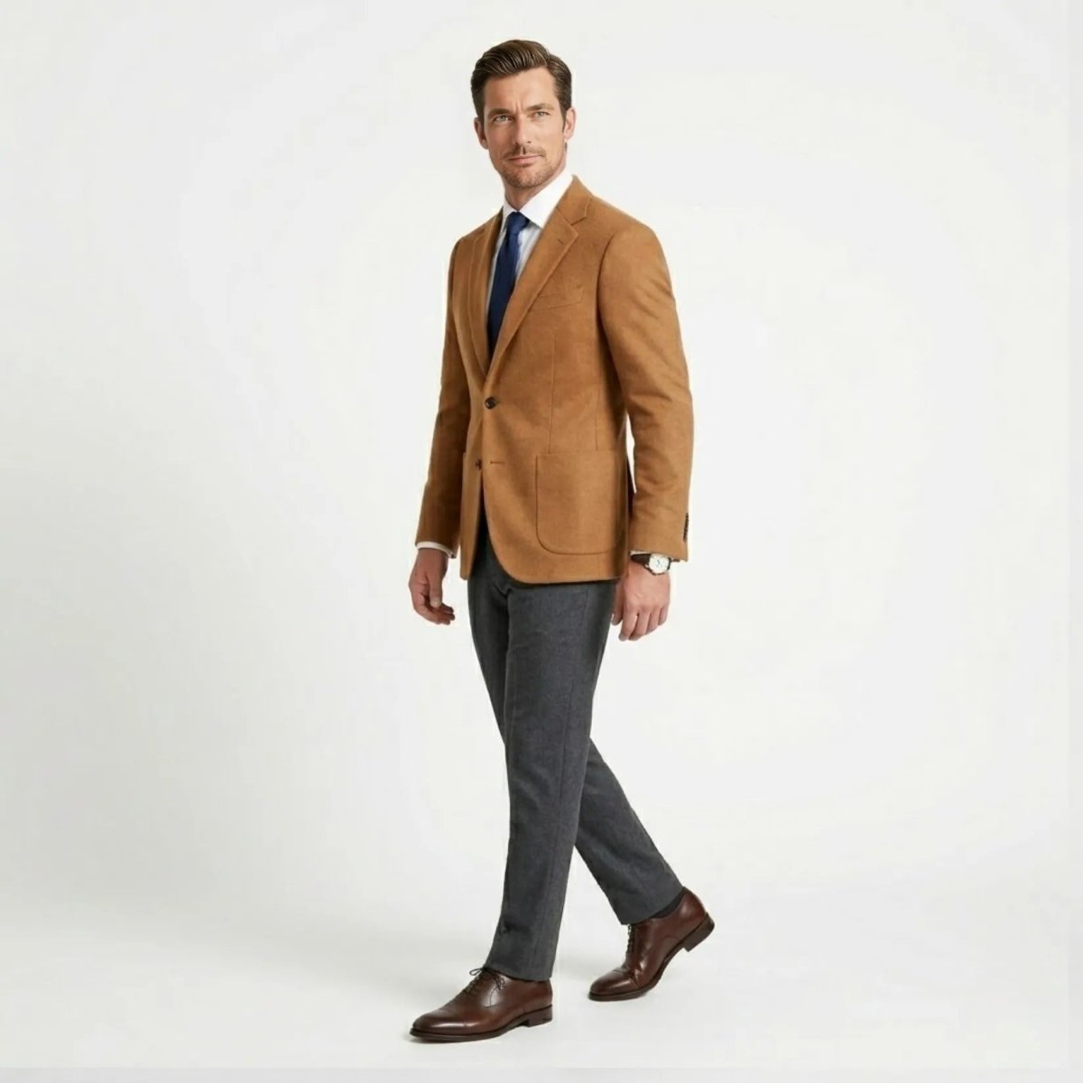 Side profile of male model walking in the smart casual Kouvr camel blazer