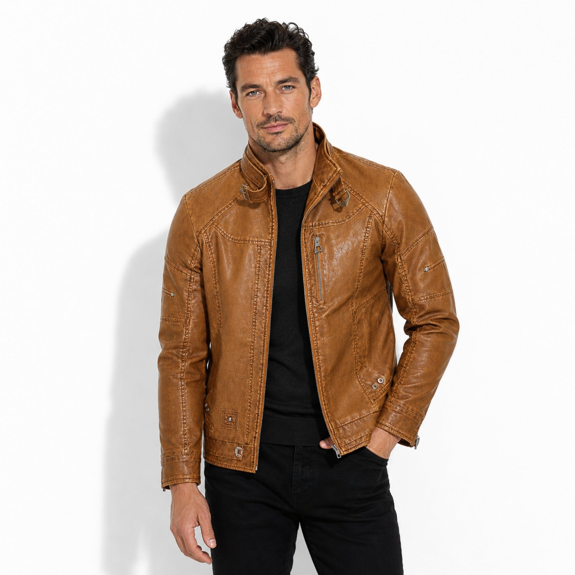 Male model styling the Kouvr mens cognac tan light brown leather moto jacket with black denim.