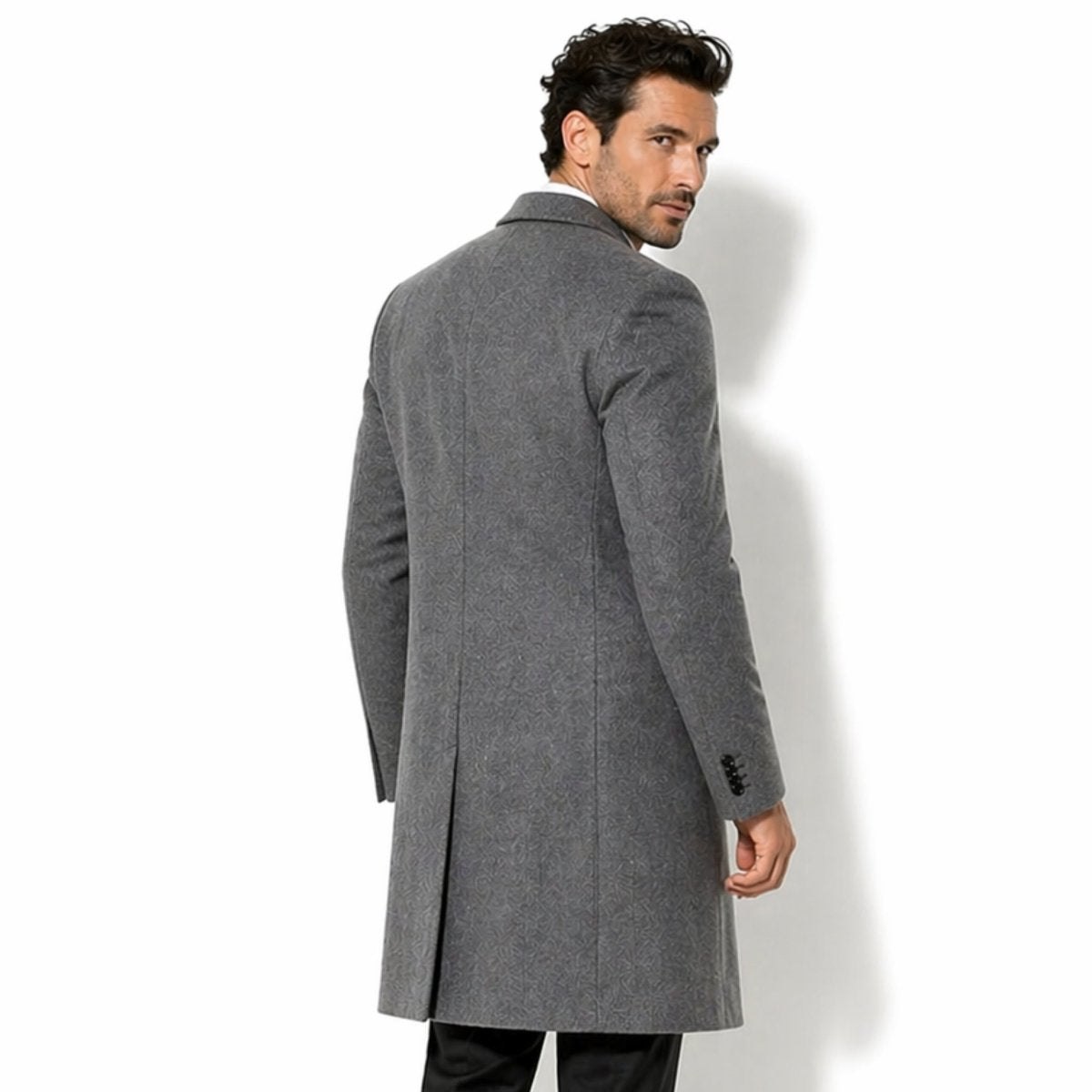Back styling of Kouvr men's grey patterned topcoat highlighting the tailored fit, classic collar, and single back vent for elegant movement.