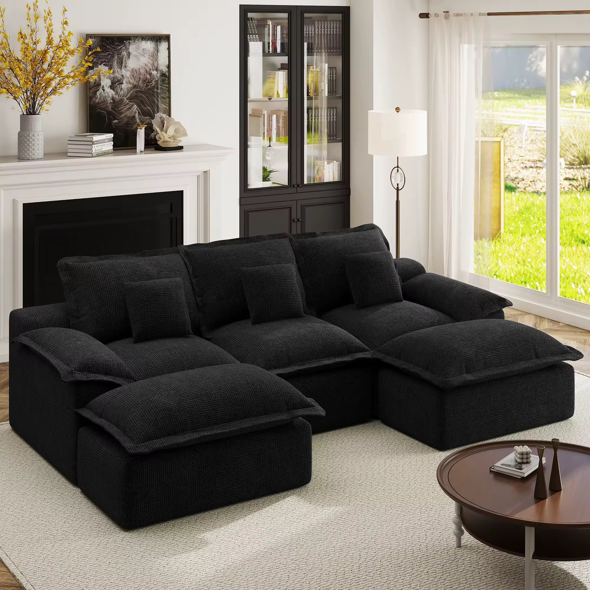 Black pit-style modular sofa contrasted against charcoal grey walls and a dark plush rug for a modern look.