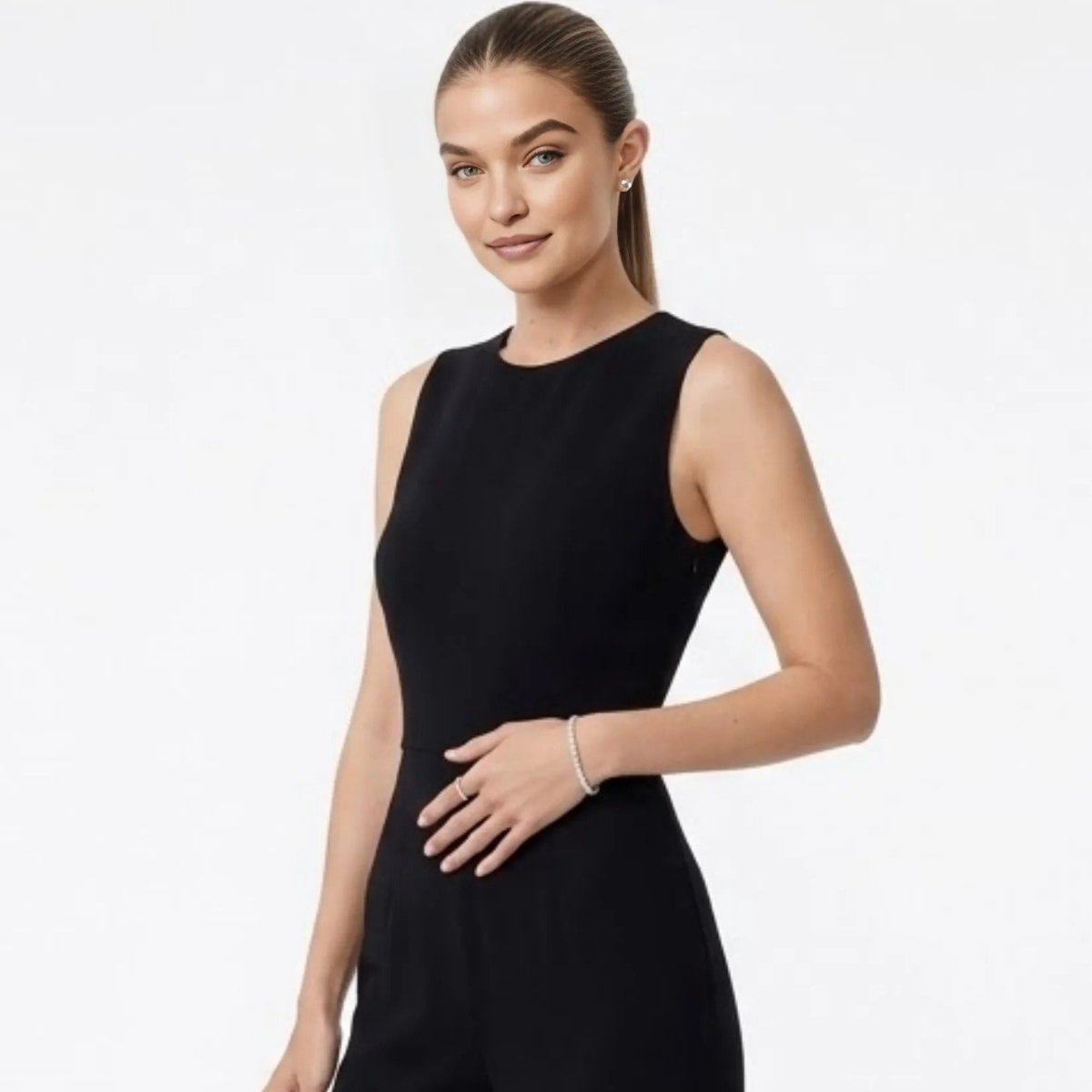 Model wearing a sophisticated black jumpsuit and the Kouvr silver stretch tennis bracelet, showcasing its versatility.

