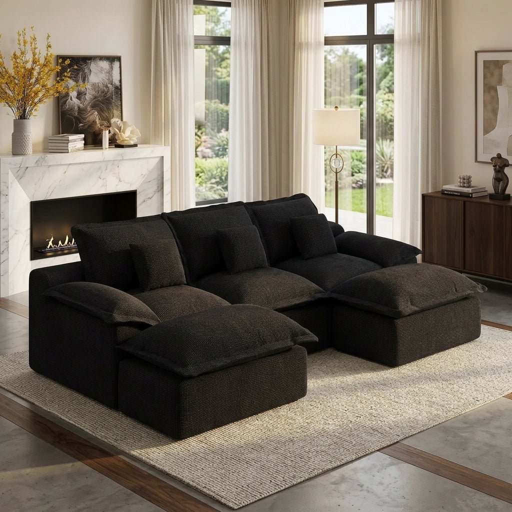 Large black corduroy modular sectional sofa with two ottomans in a bright, modern living room with a fireplace.