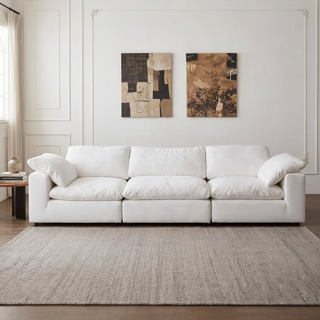 Front view of the Kouvr Nimbus white modular deep seat sofa in a modern minimalist living room.