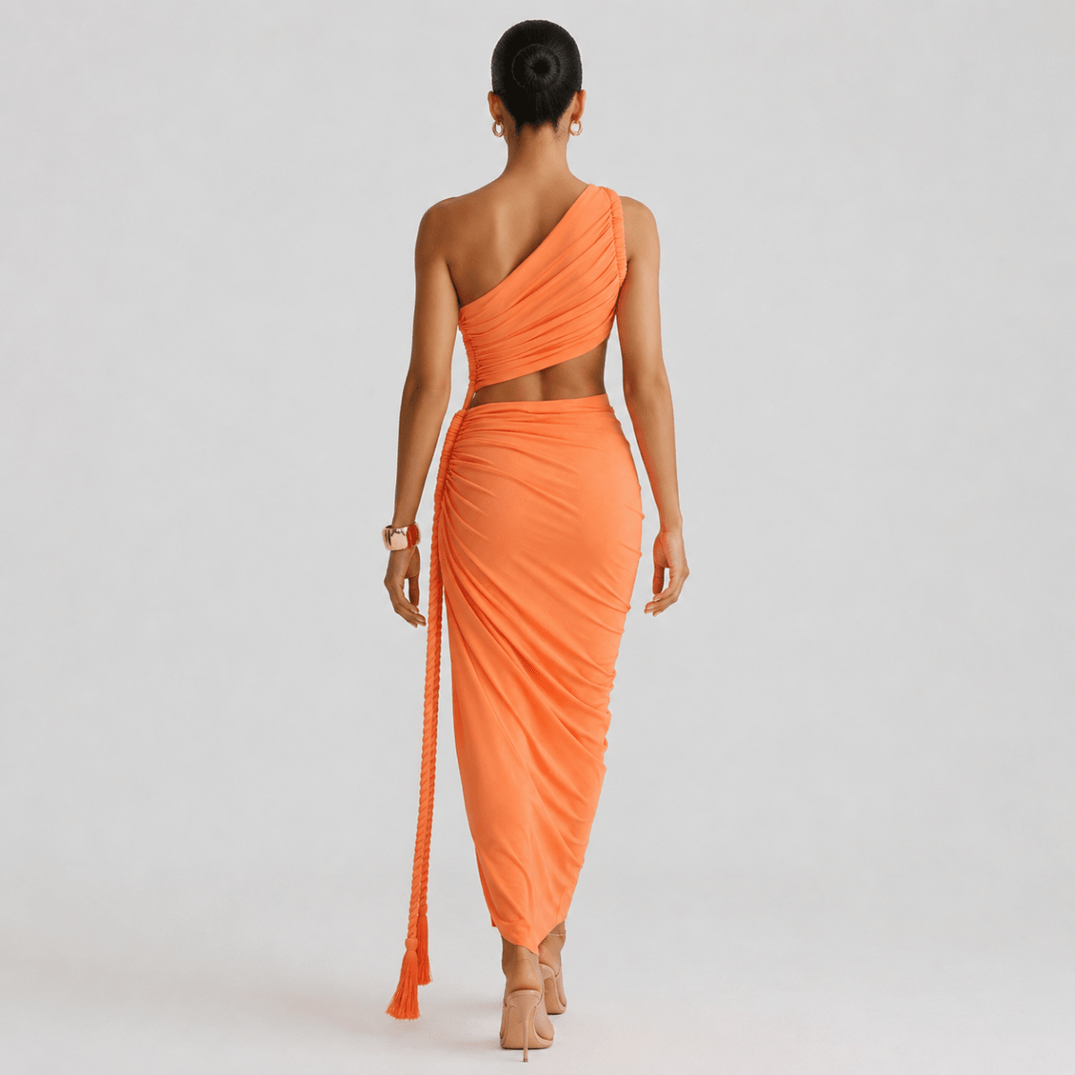 Back view of the orange asymmetrical ruched vacation dress highlighting the seamless drape, bodycon fit, and one-shoulder strap.
