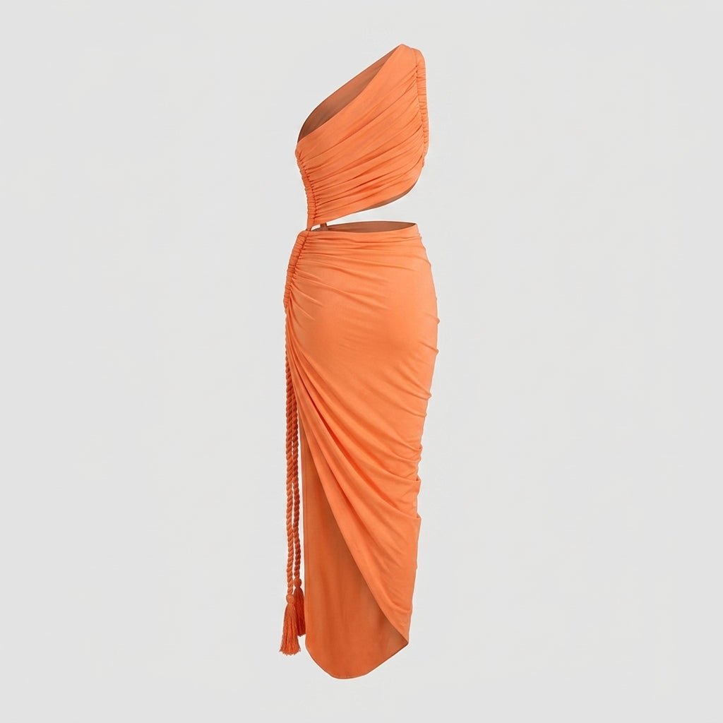 Detailed view of the orange luxury resort wear dress displaying the one-shoulder bodice, waist cutout, and tactile flowing fabric.