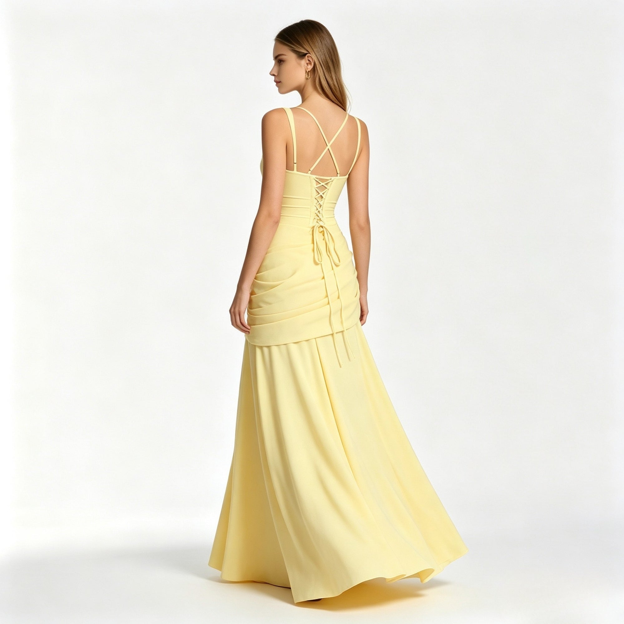 Back view of a pale yellow formal maxi dress showcasing an adjustable lace-up corset back, spaghetti straps, and trailing fabric ties.
