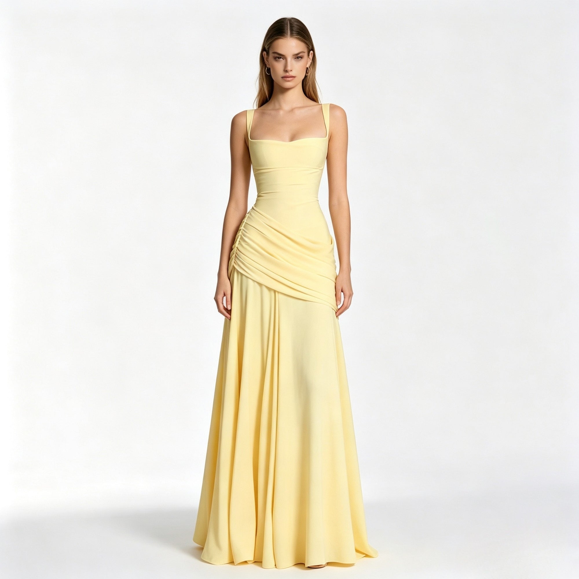 Woman modeling a pale yellow square neck formal evening gown with ruched waist by Kouvr, standing facing forward against a white studio background.