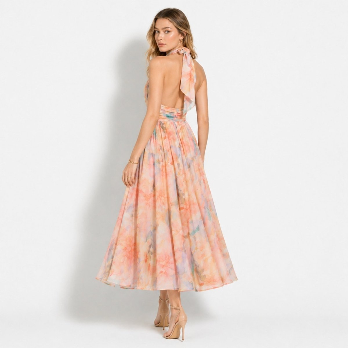 Back view of woman showing the open back and neck tie detail of the Kouvr floral halter dress