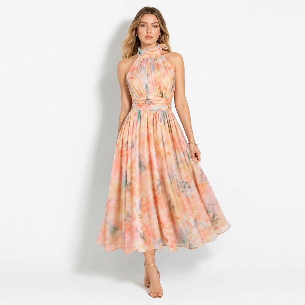 Woman wearing Kouvr pastel floral halter midi dress standing facing forward with nude heels