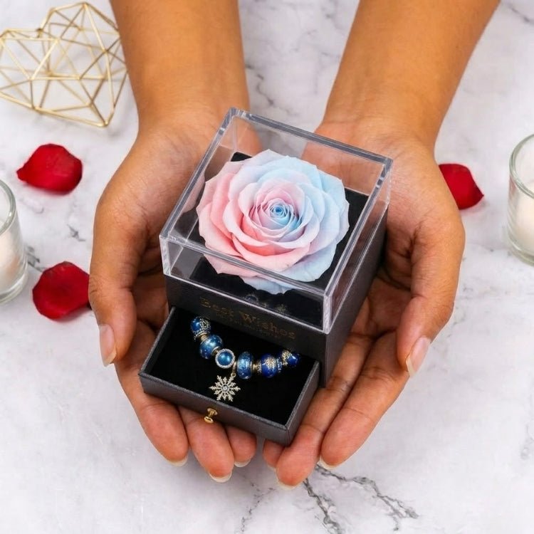 Person holding a soft pastel pink and blue ombre preserved rose gift box, a sweet Valentine's or anniversary gift idea for her.