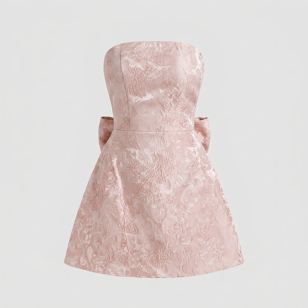 Studio flat lay product shot of a light pink floral brocade strapless A-line dress.