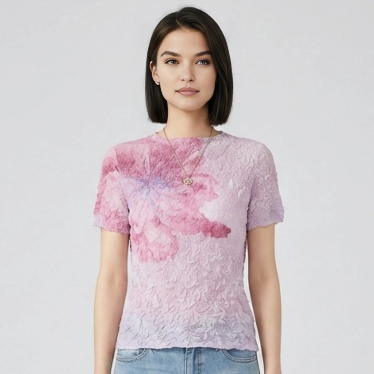 Close up detail of Kouvr 3D bubble textured pink and purple floral t-shirt on female model