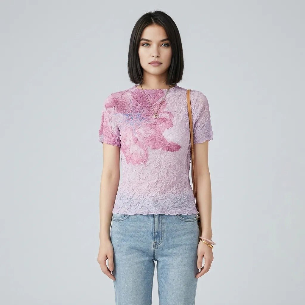 Woman wearing Kouvr pink floral textured crinkle short sleeve top facing forward against grey background