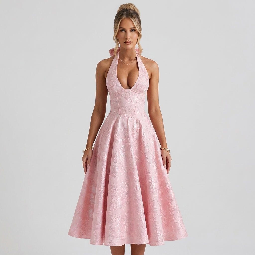 Three quarter angle lifestyle view of pink corset A-line midi dress showcasing plunging neckline and full skirt.