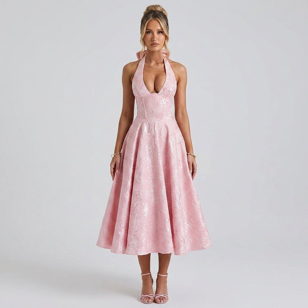 Front view of fashion model wearing Kouvr pink floral jacquard halter midi dress with corset bodice and deep v-neck.