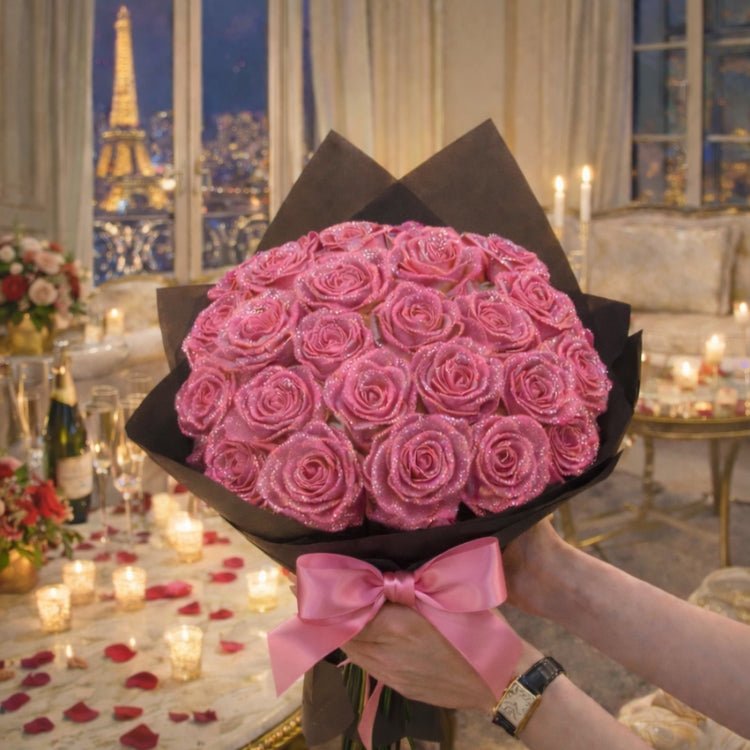 A romantic bouquet of pink glitter roses with a matching pink ribbon. Beautifully wrapped handmade flowers held by hands with a watch.