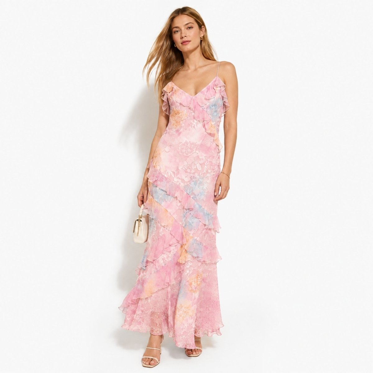 Woman modeling Kouvr pink pastel floral lace dress with tiered ruffles and elegant draping