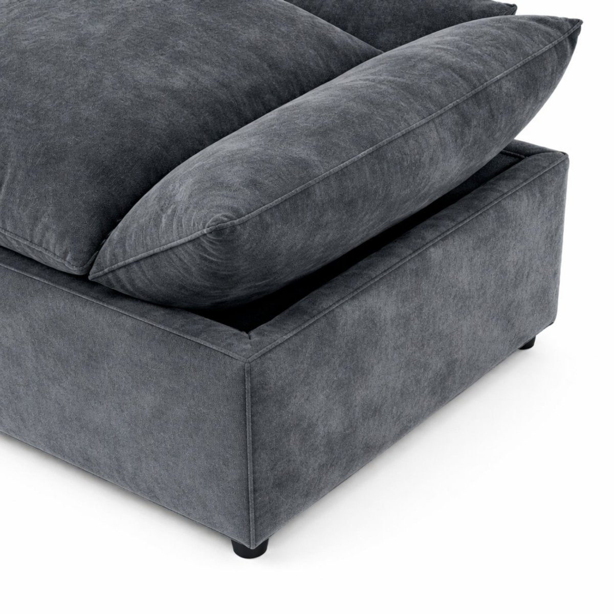 Close up of plush padded overhanging armrest on dark grey sectional