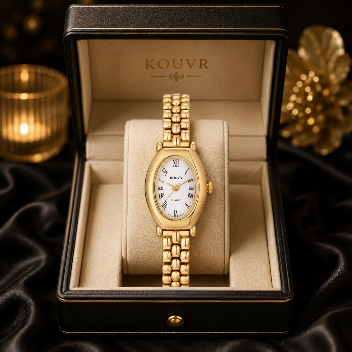 Elegant Kouvr gold oval face ladies watch showcased in a luxurious black presentation box against a dark silk background.