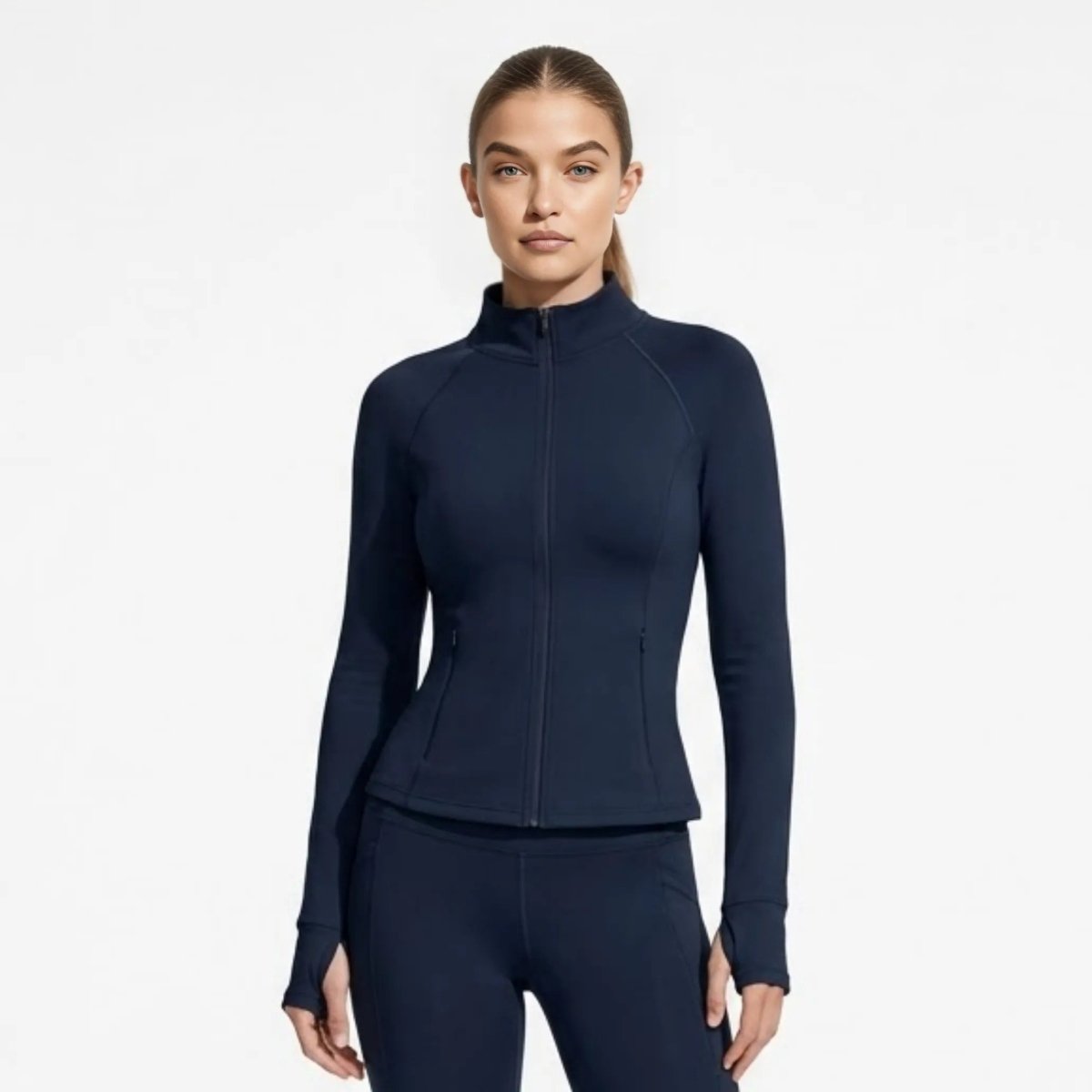 Woman wearing Kouvr premium navy blue full zip athletic jacket looking at camera