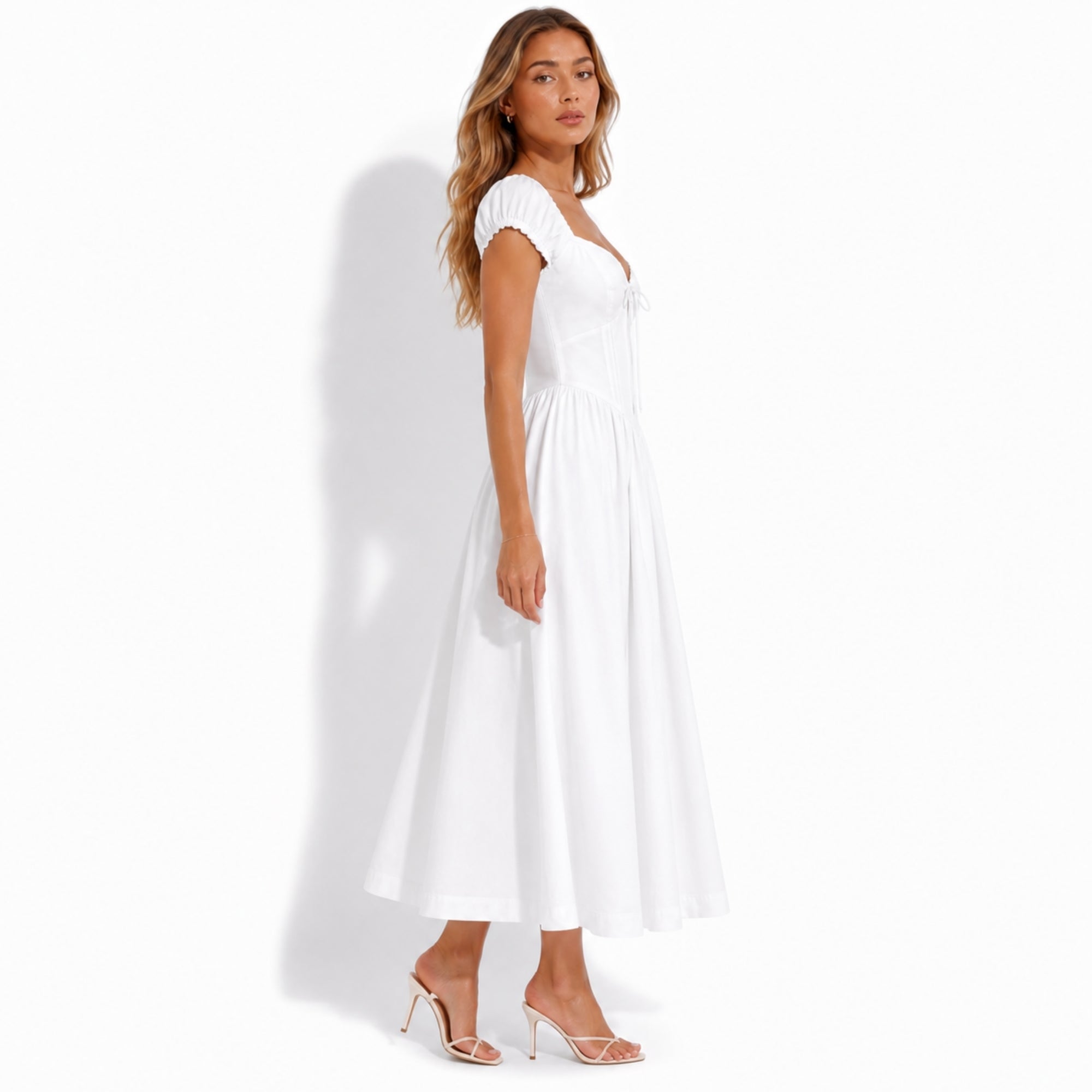 Side profile of woman in elegant white sweetheart tea dress showing flattering corset waist