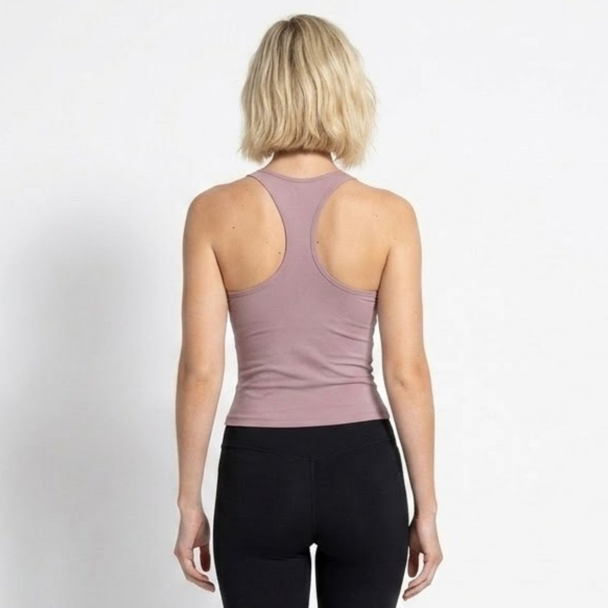 Back view showing the racerback design of the Kouvr purple activewear tank top.