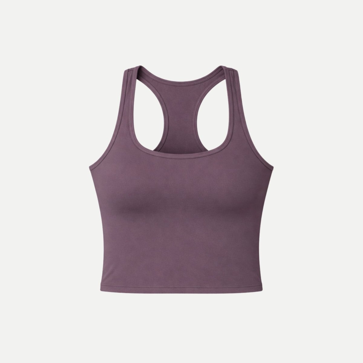 Flatlay front view of Kouvr purple scoop neck workout crop top on white background.