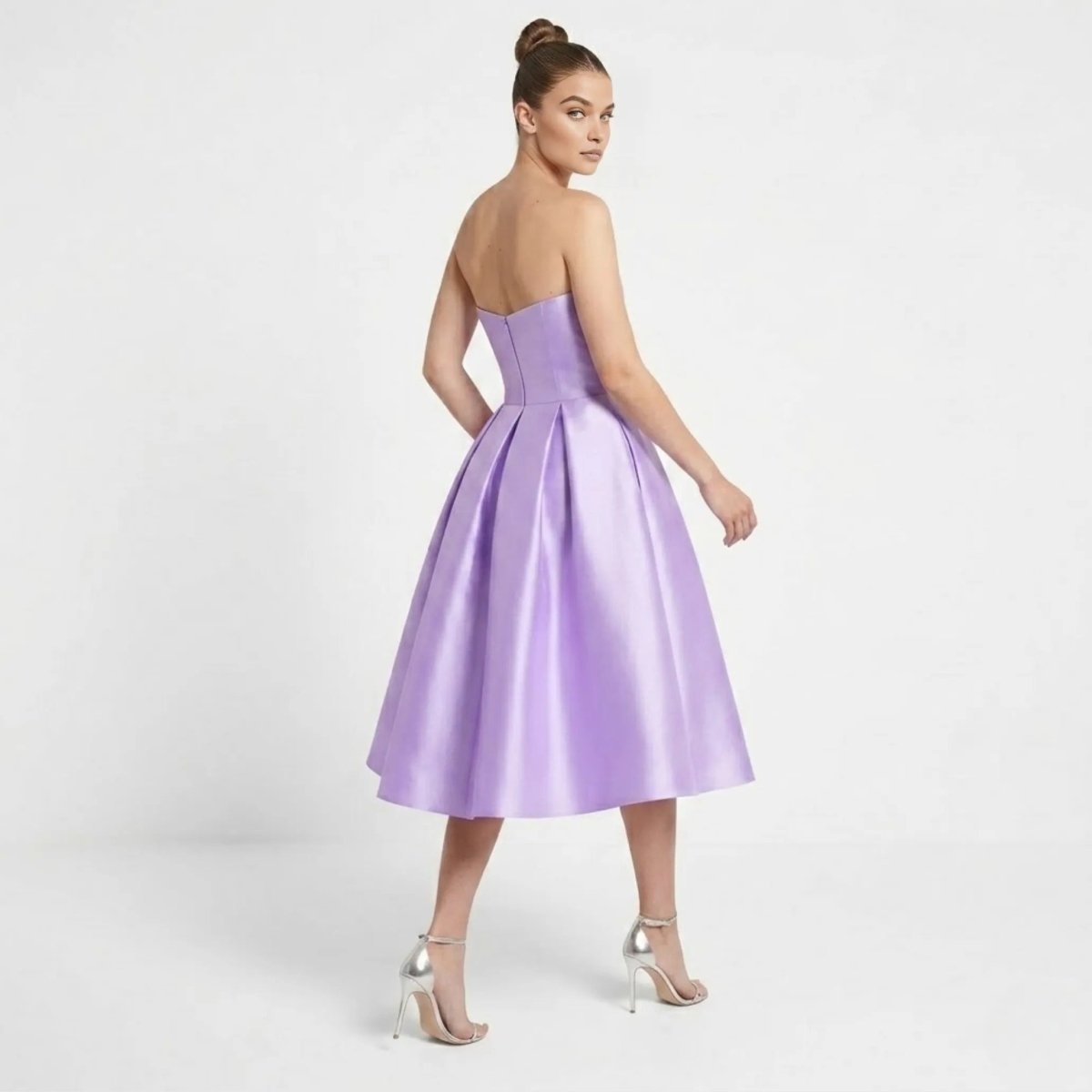 Back view of the Kouvr purple formal cocktail dress highlighting the invisible zipper and sweeping pleated skirt.