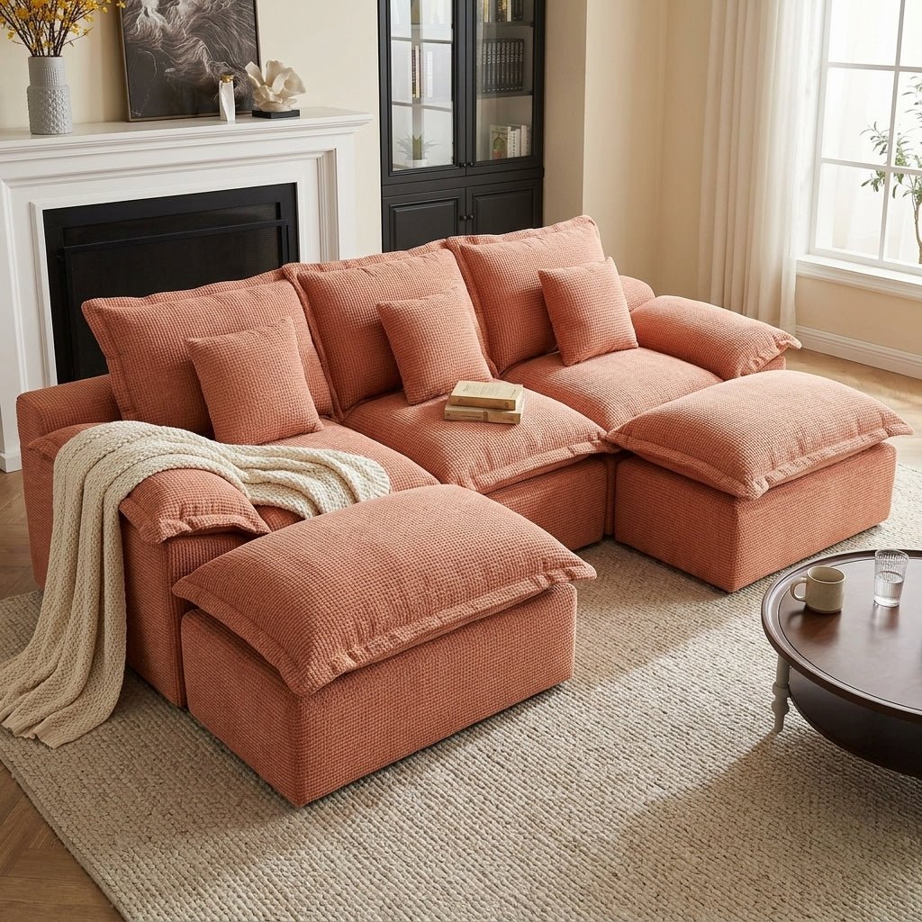 Rust orange modular pit sofa styled with a cream knit throw blanket and soft textured back cushions.
