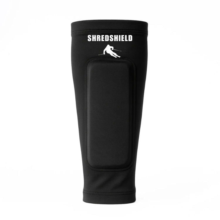 Front view of the navy black ShredShield ski shin guard with a matching black gel protective pad and white logo, against a plain white background.