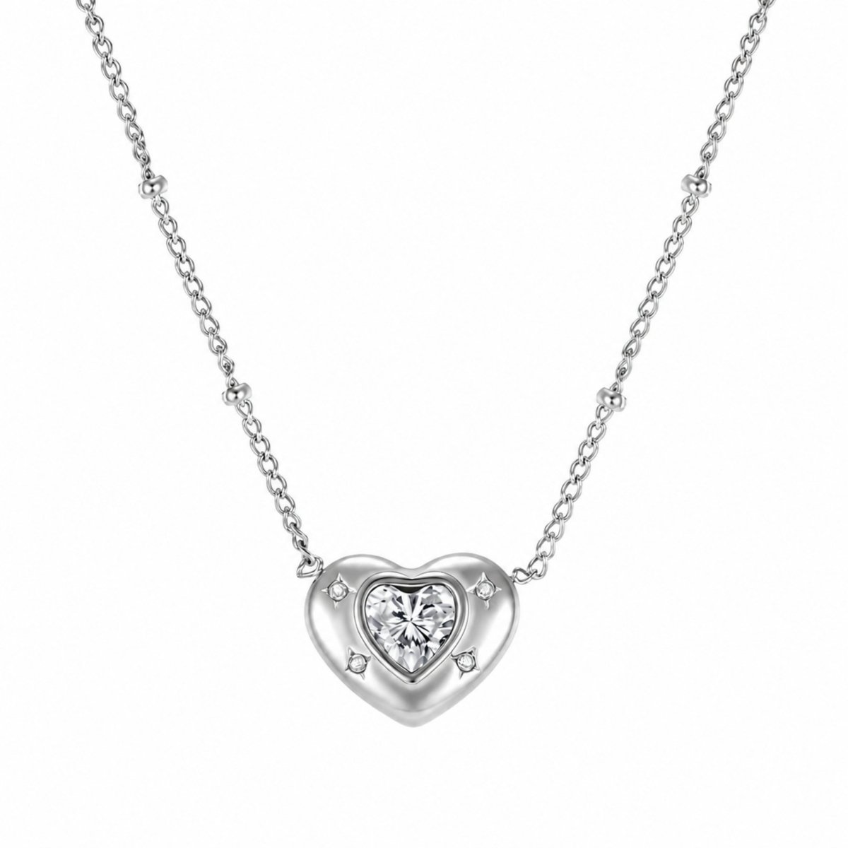 Close-up of Kouvr silver heart pendant necklace featuring a central crystal and dainty beaded satellite chain.