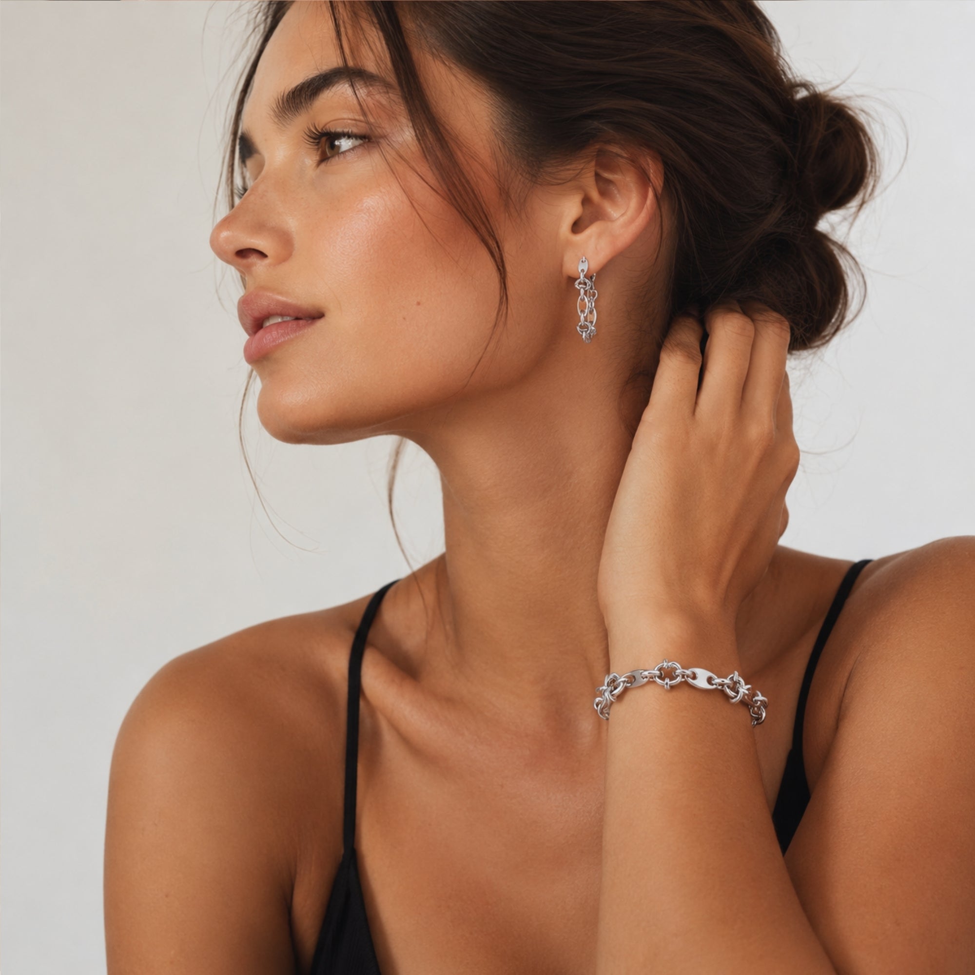 Sophisticated model showcasing the silver stainless steel chunky knot link bracelet styled casually highlighting its versatile, lightweight design.