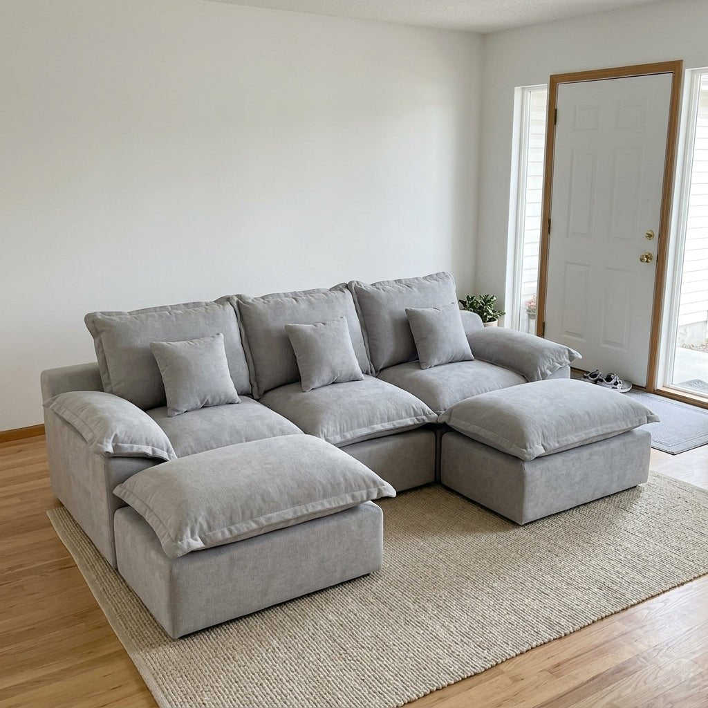 Cozy night setting featuring a grey cloud-style sectional sofa under warm floor lamp lighting in a modern home.