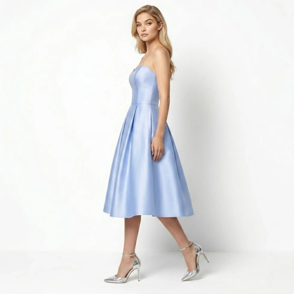 Side profile of woman modeling the powder blue formal tea length cocktail dress showing fitted bodice structure
