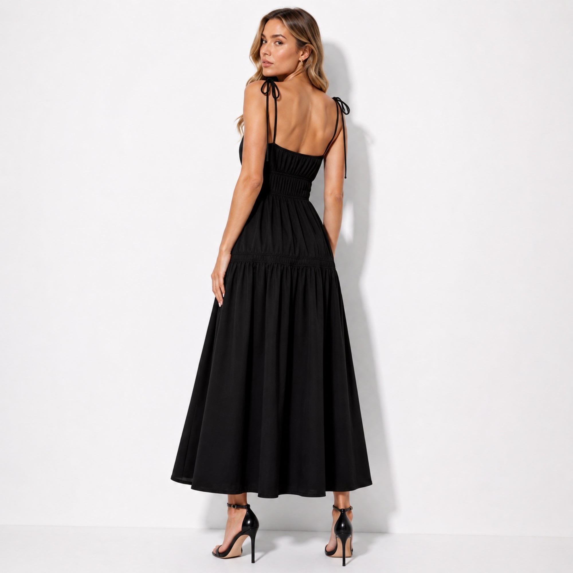 Back view of black elevated maxi dress showcasing delicate tie shoulder straps
