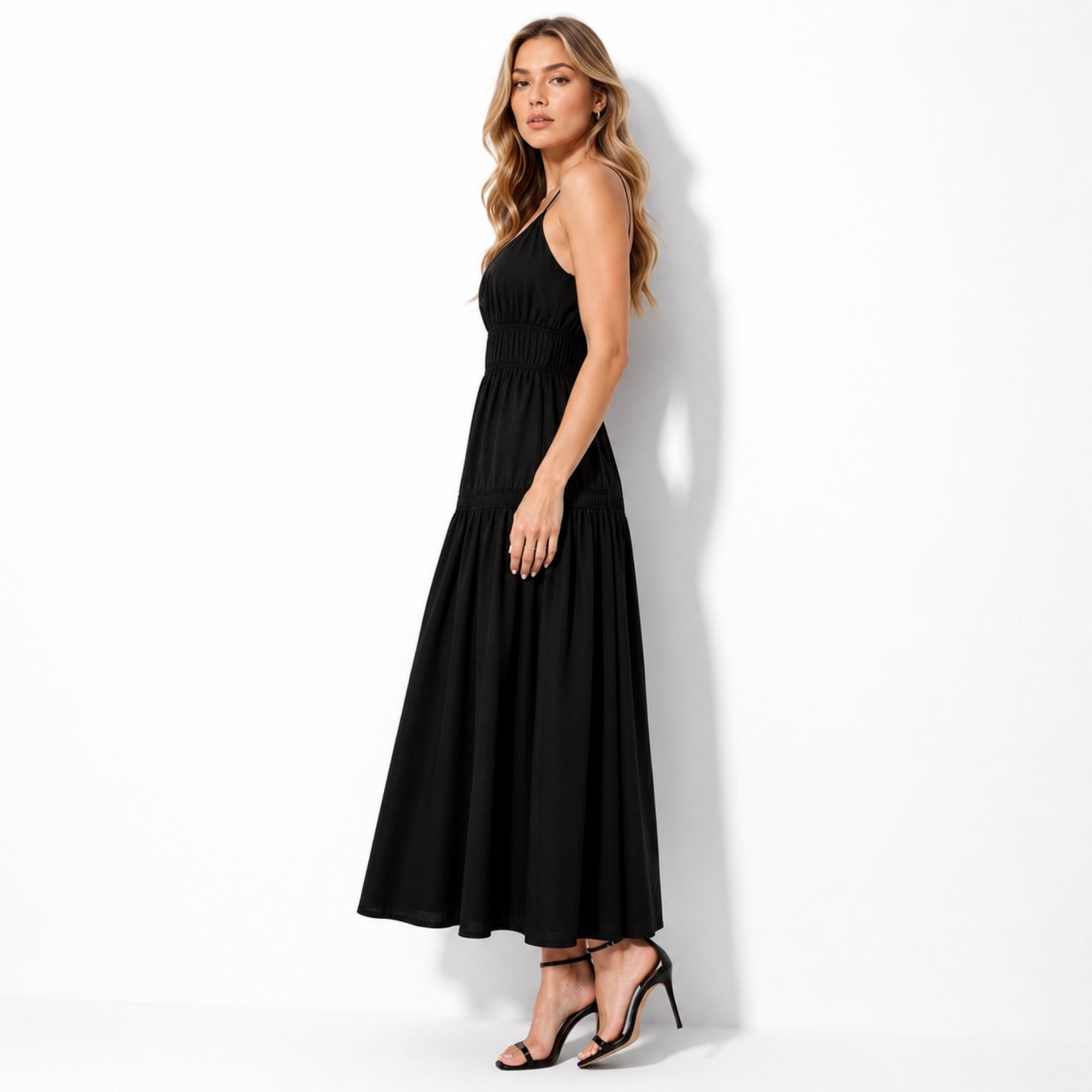 Side view of black luxury resort wear maxi dress with elegant flowy skirt