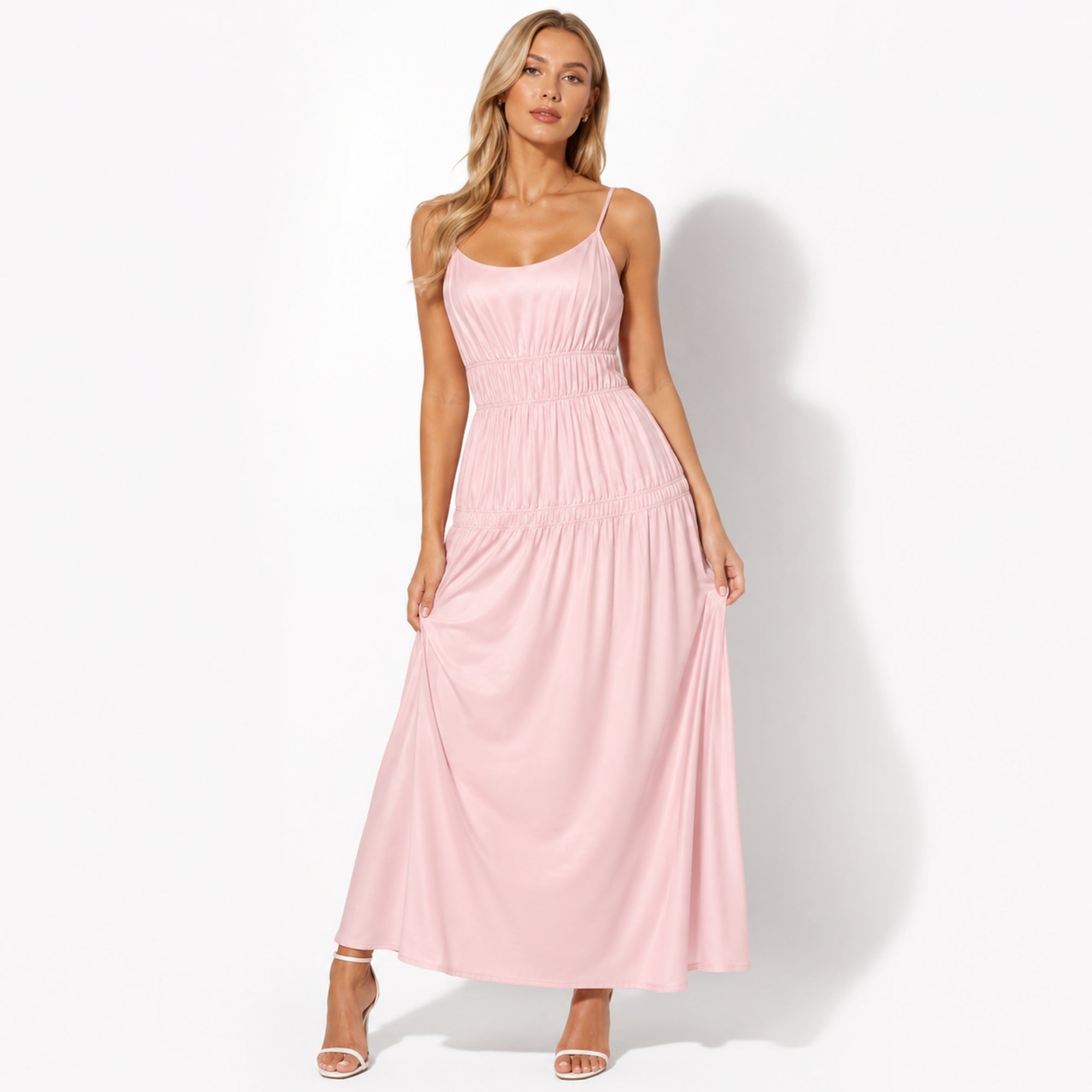 Woman modeling a light pink smocked waist tiered maxi dress with scoop neckline