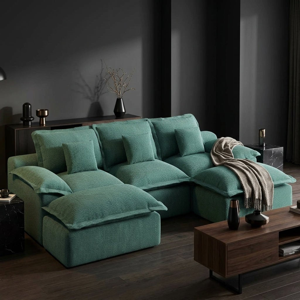 Side profile of a teal modular sofa showing the thick back cushions and overstuffed seat texture.